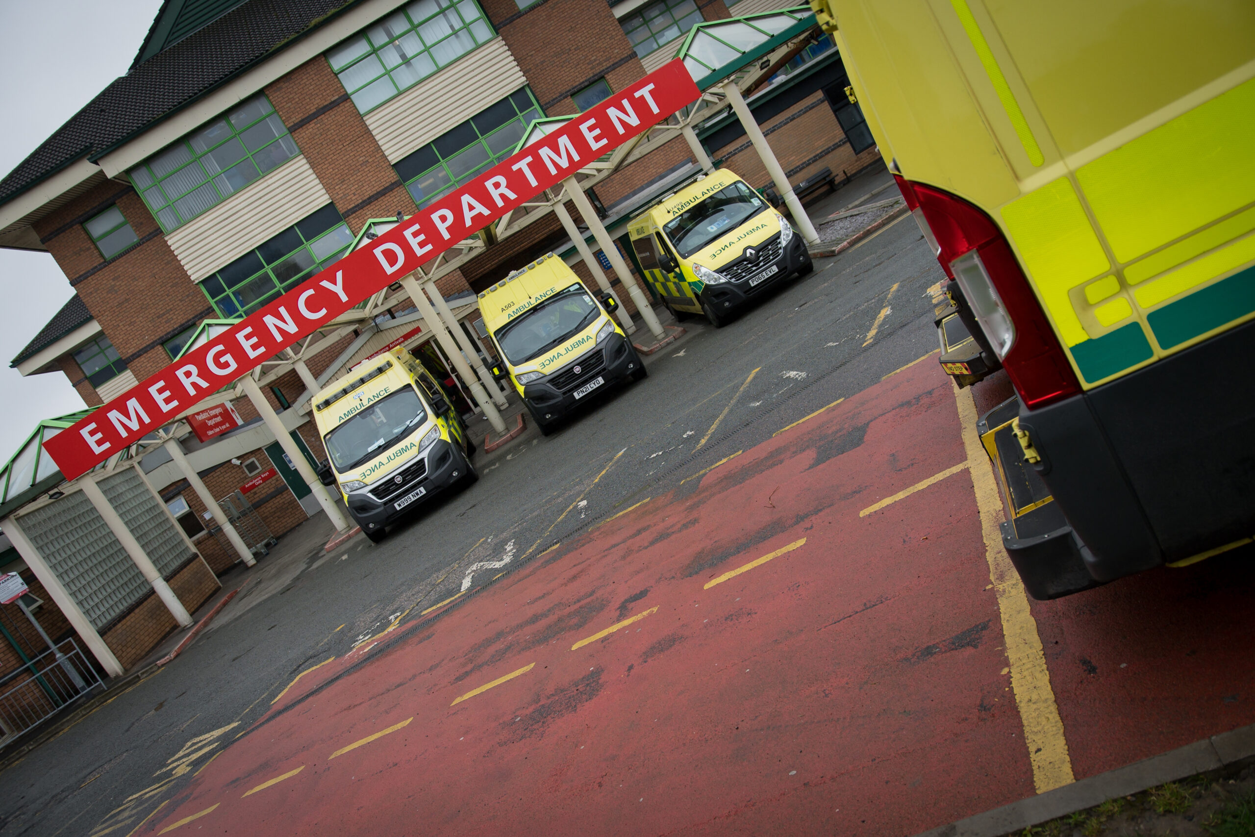 Row of ambulances parked outside Emergency Department at Royal Bolton Hospital