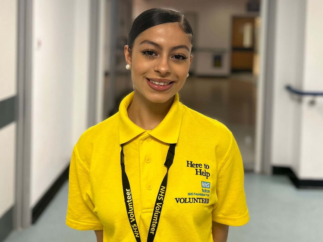 Volunteer Silvana Rushdi wears a bright yellow tshirt