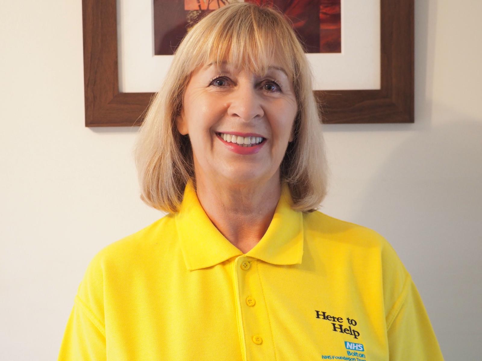 Volunteer Stephanie Egan wears a bright yellow tshirt